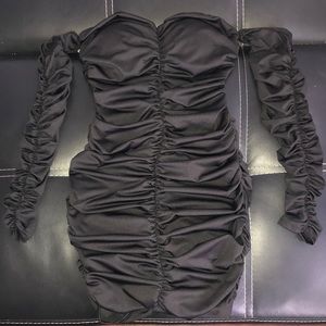 A black mini bodycon dress from fashion nova